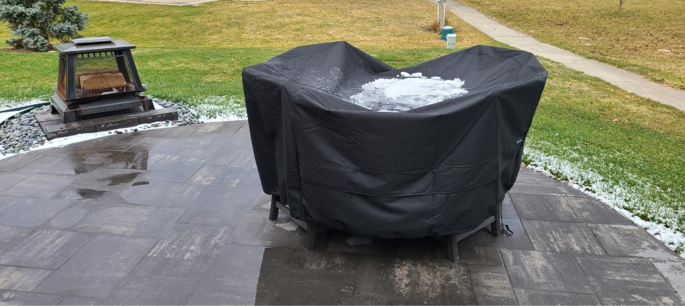 Rectangular green air bag on a table with a cover being pulled over it