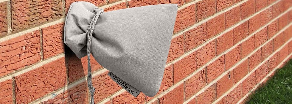 Grey faucet cover on brick house