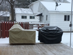 Two grill covers in snow