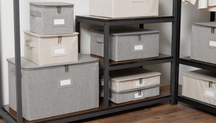 Stack of different size zip-top storage boxes in a closet