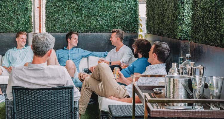 Group of friends sitting on patio furniture together