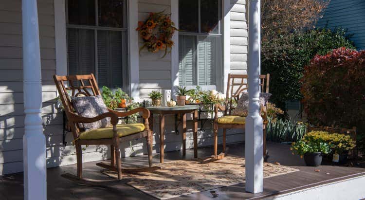 Porch with two chairs and many plants