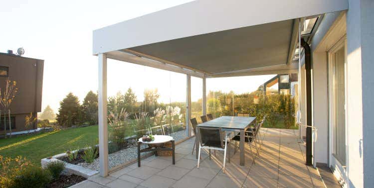 Dining table and chairs beneath a covered patio