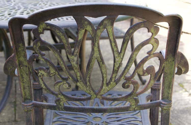 Outdoor metal chair covered in mold