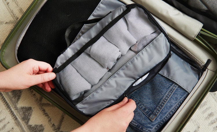 Packing cubes being placed in a suitcase