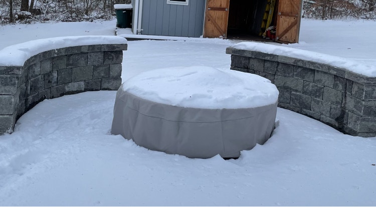 Fire pit cover with snow on top