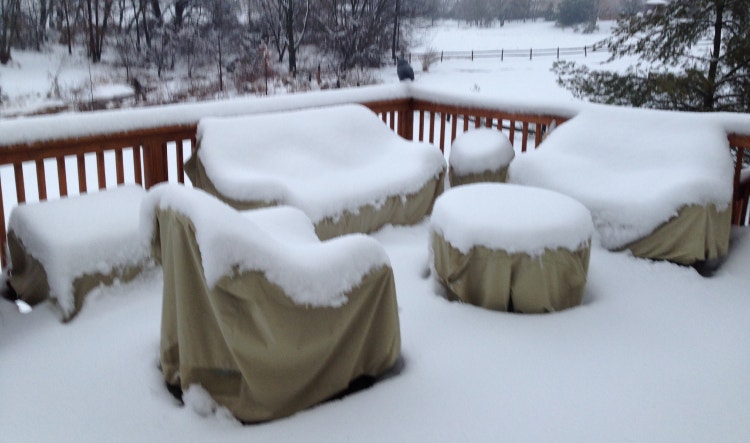 Covered patio furniture with snow on top