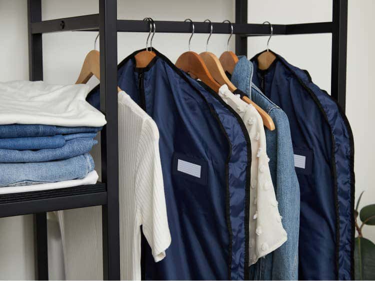 Garment bags hanging in a closet